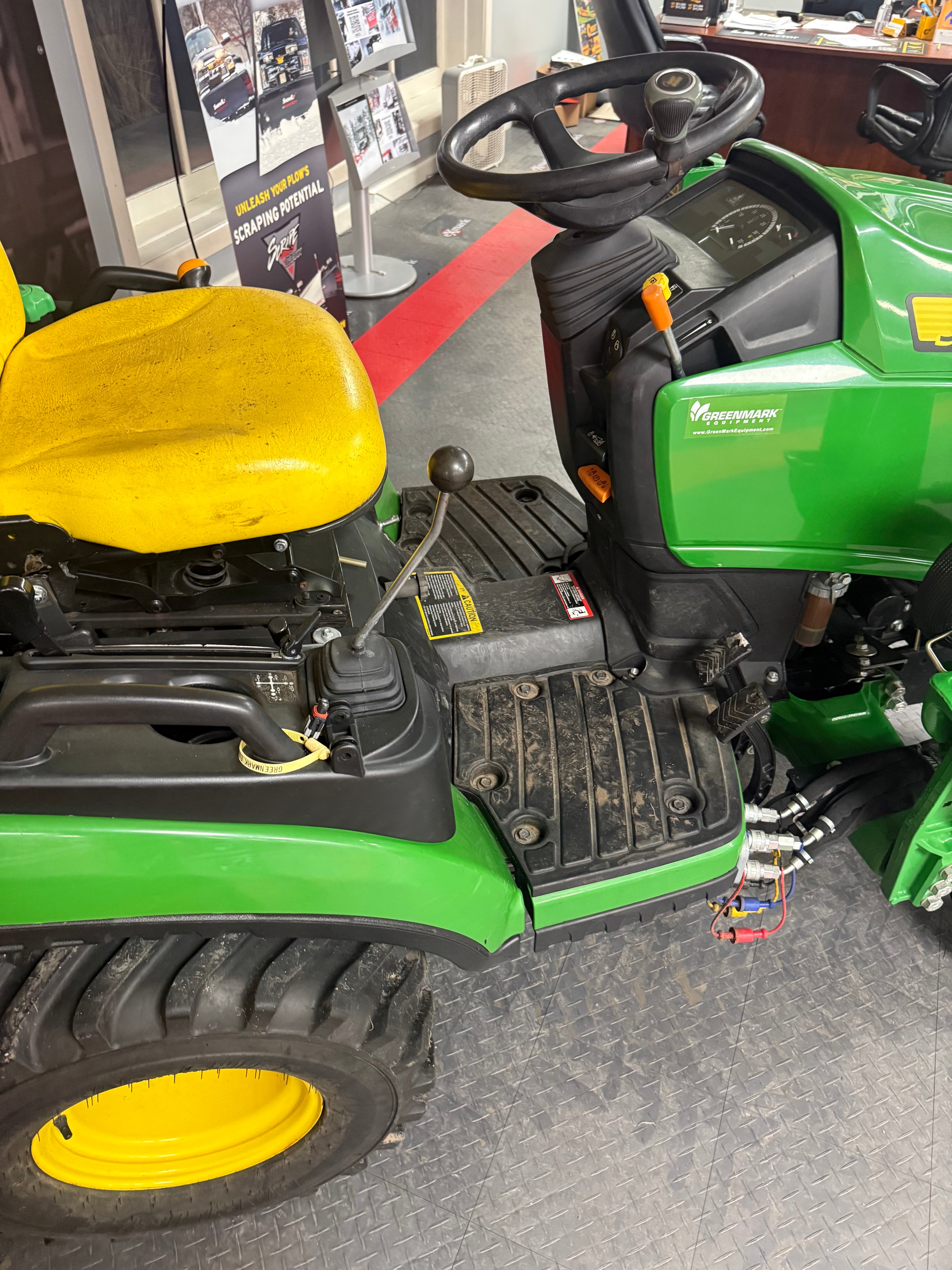 Close-up of a green John Deere lawn mower with visible branding.