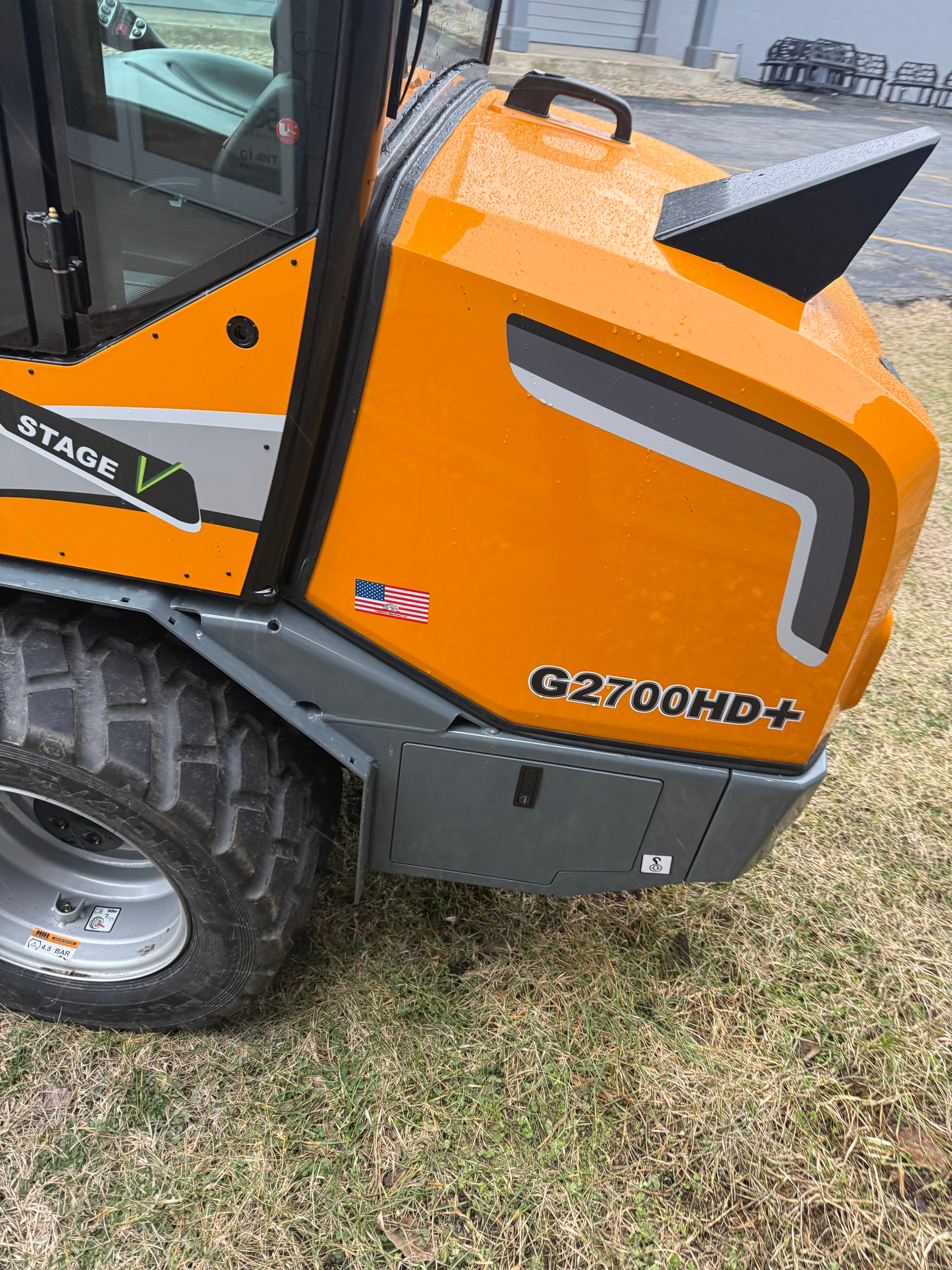 Orange and gray piece of construction equipment on grass