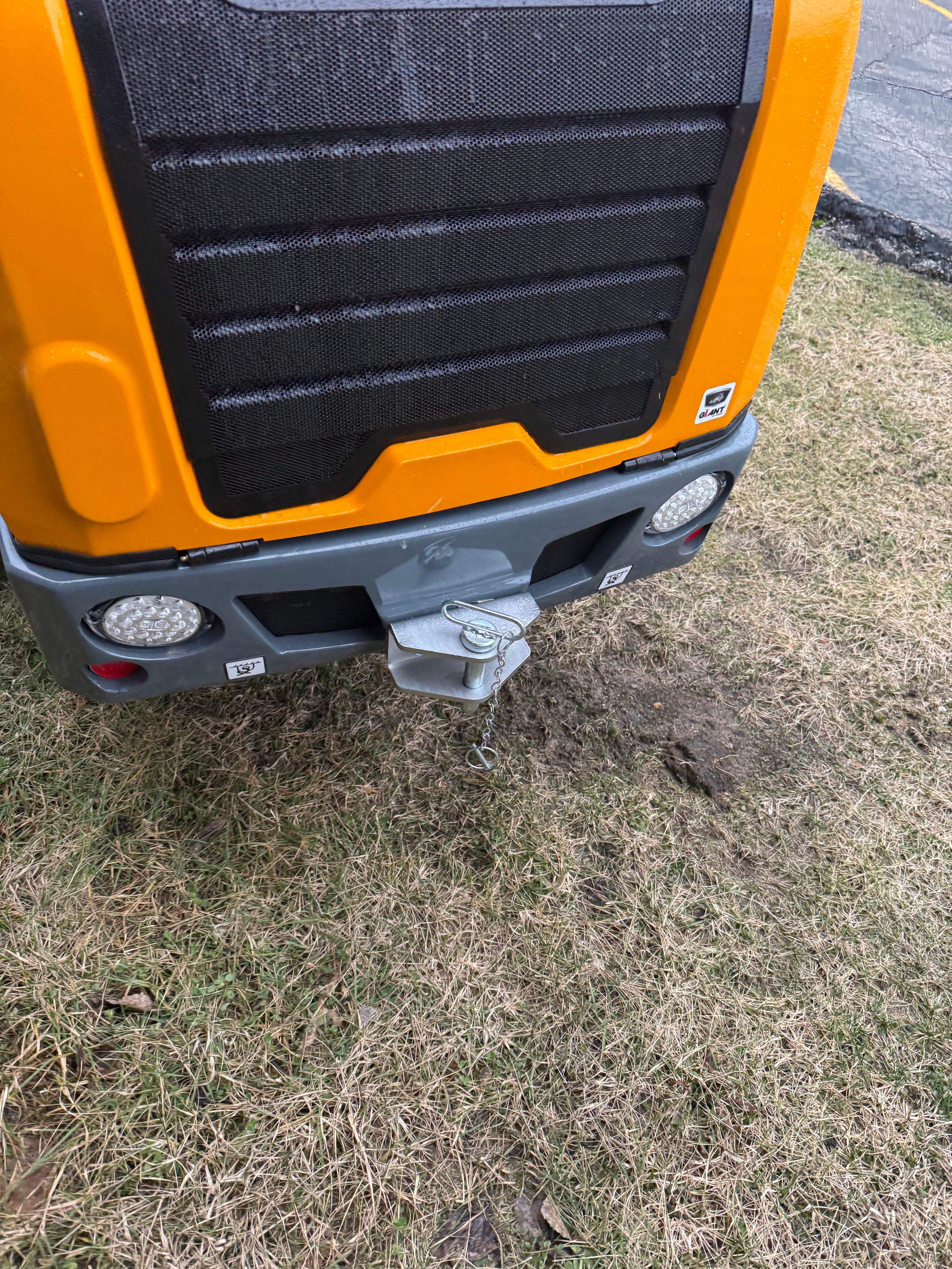 Orange and black tool on grass