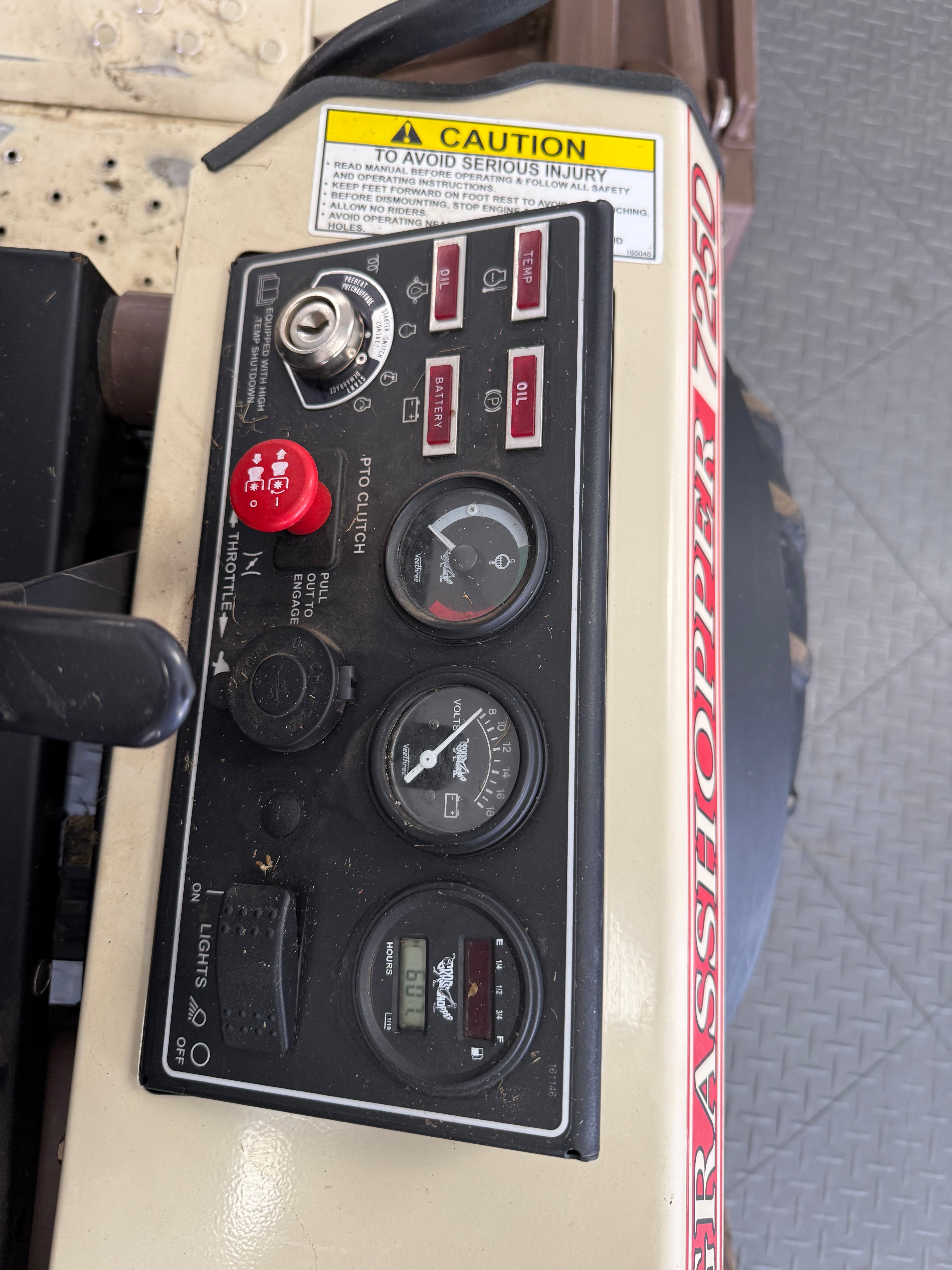 Control panel with gauges and switches on a machine, featuring a visible brand name.
