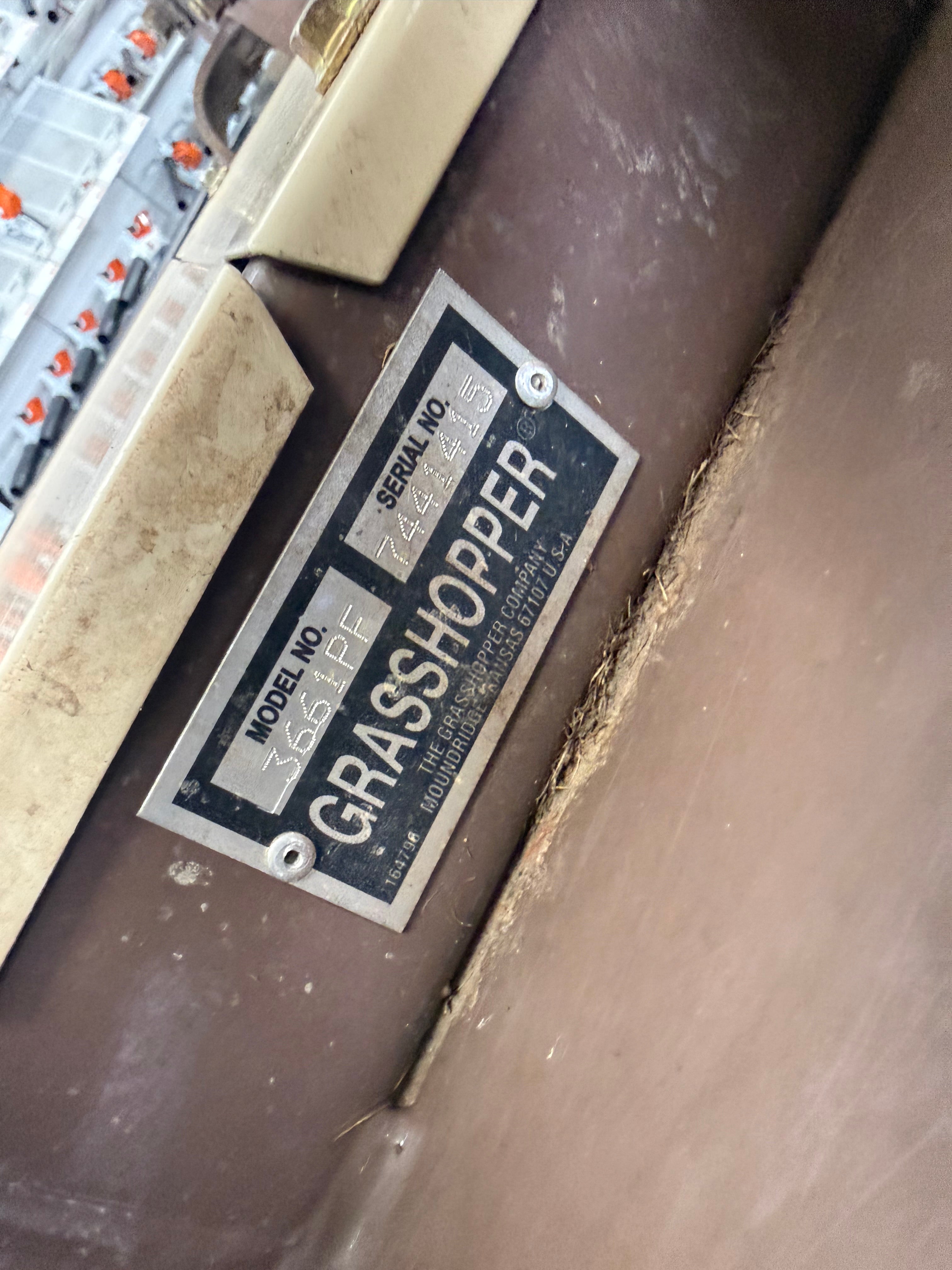 Label on a piece of equipment with 'Grasshopper' branding in an industrial setting.