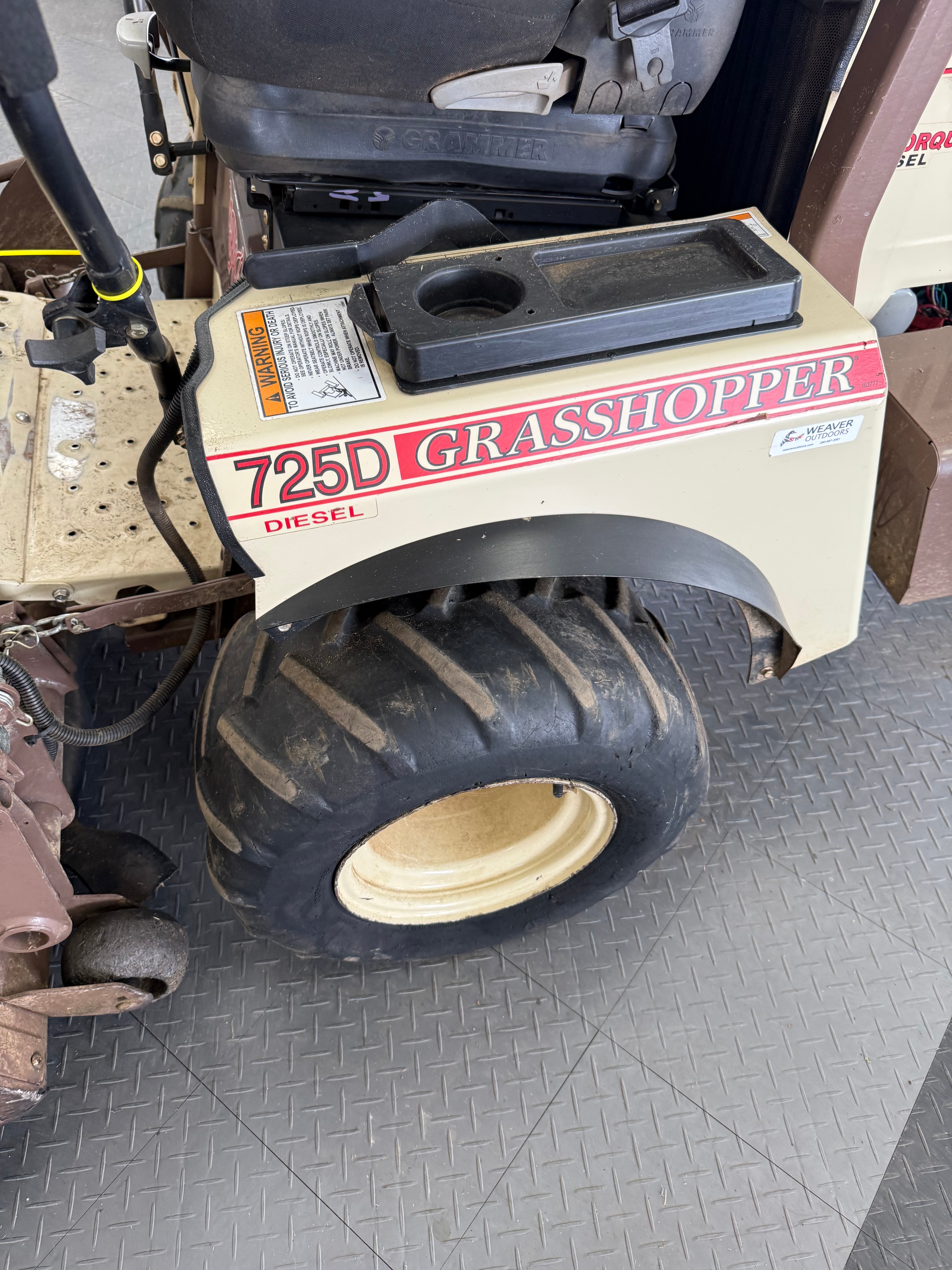 Grasshopper lawn mower on a tiled floor