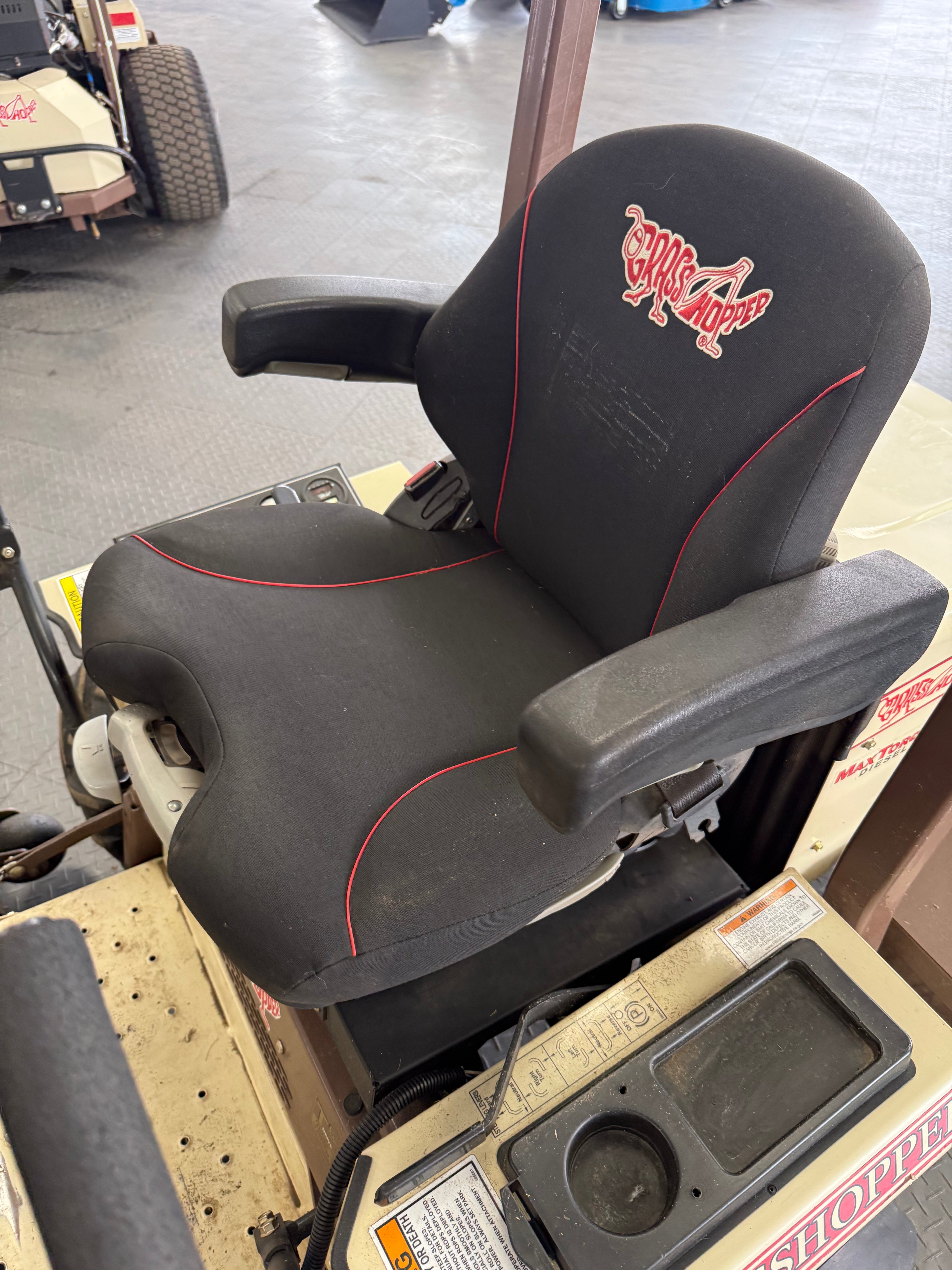 Black car seat with red logo on a vehicle interior