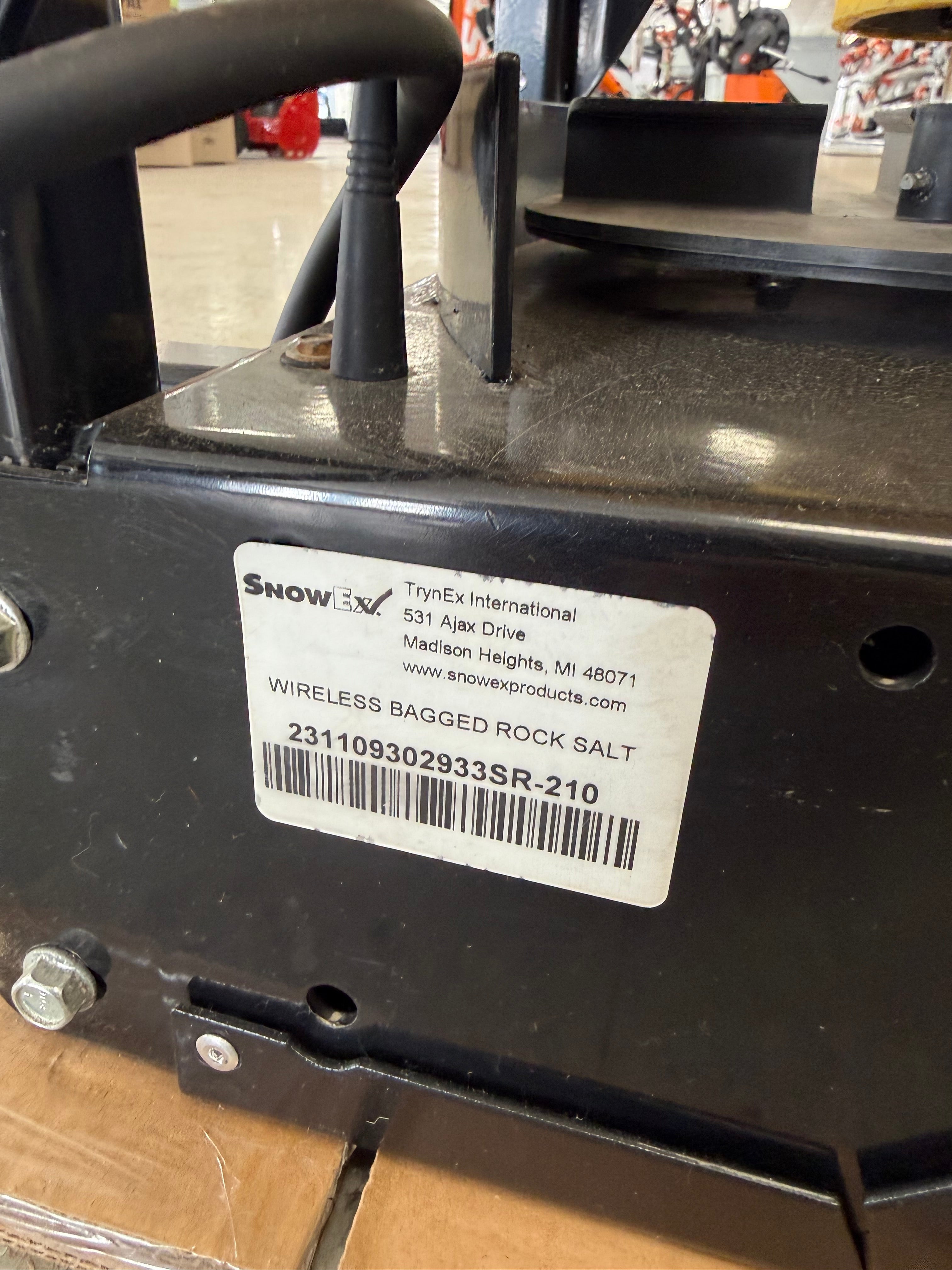 Close-up of a black electronic device with a label and barcode on a blurred background